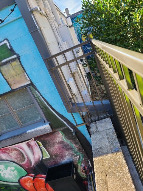 Powder-coated ornamental metal railing along outdoor steps in Northwest Arkansas