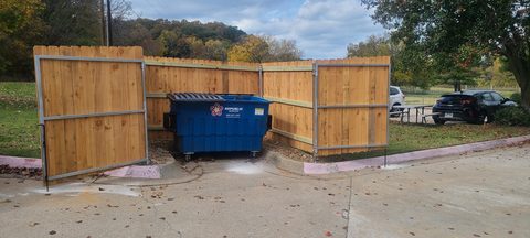 Commercial trash enclosure with cedar infill panels and steel framing in Northwest Arkansas