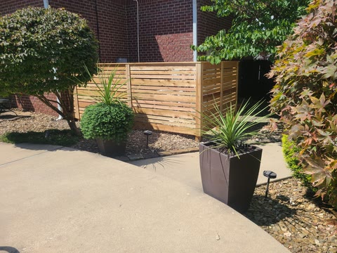 Custom cedar-slat screen enclosing pool equipment at a Northwest Arkansas property