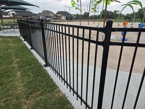 Black aluminum security fence along a splash pad and walkway in Northwest Arkansas