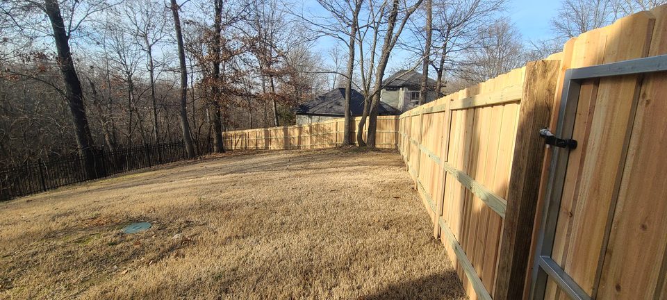 Cedar privacy fence enclosing a backyard in Northwest Arkansas